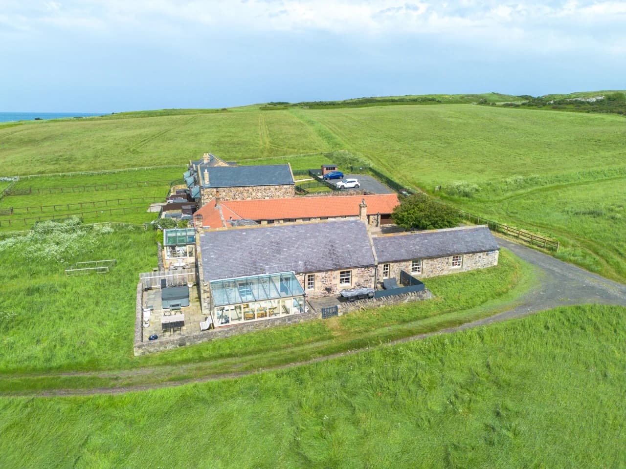 Aerial view of the cottage surrounded by open countryside