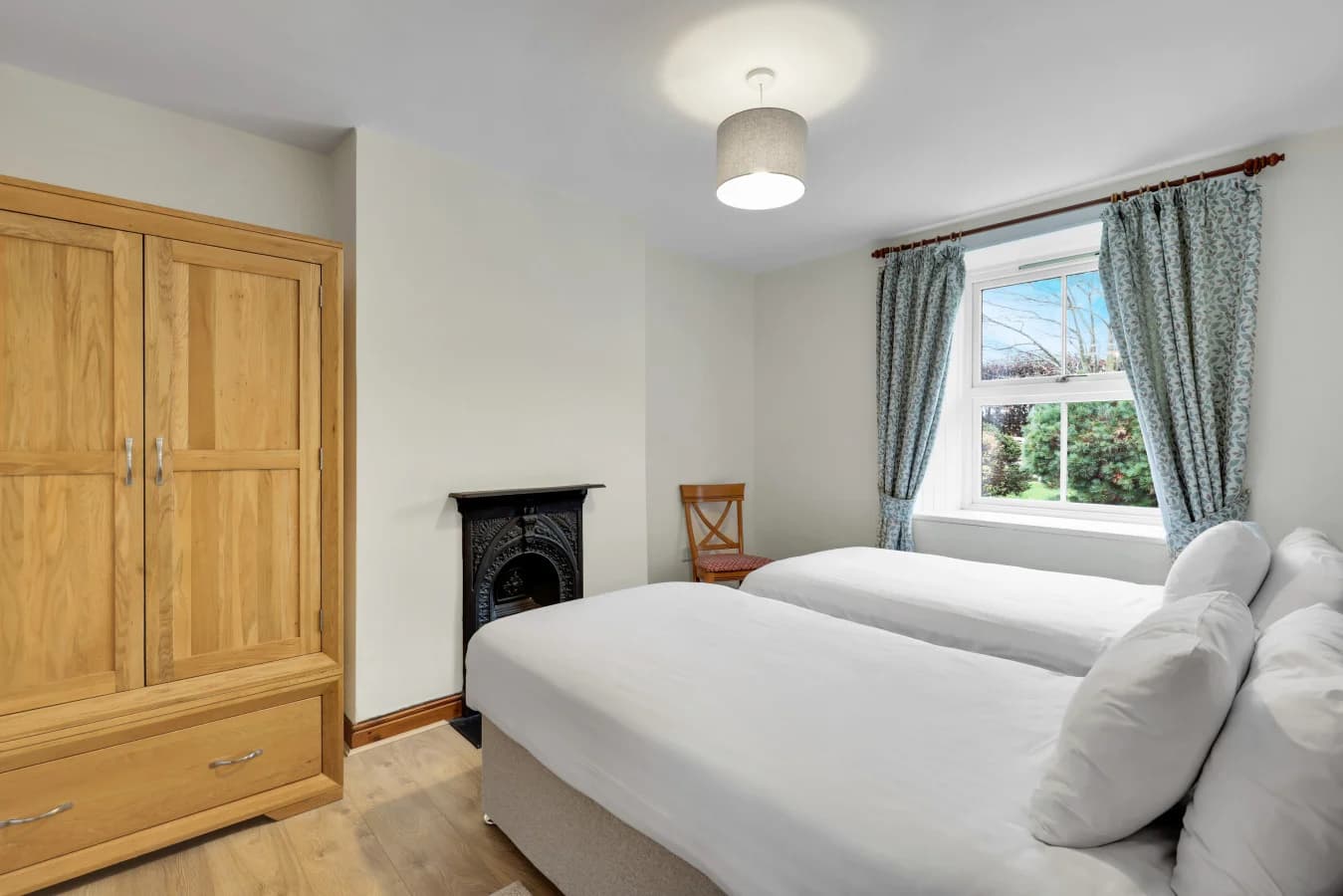 Twin bedroom with period fireplace and views across the grounds