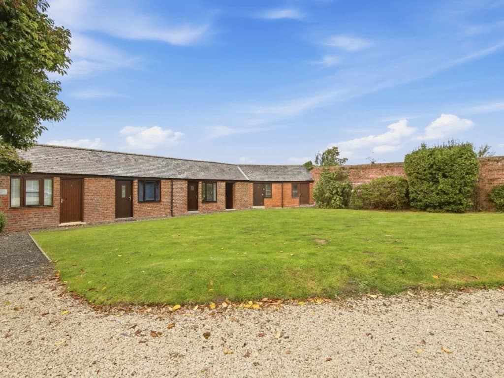 Shared garden grounds with lawn and surrounding historic buildings
