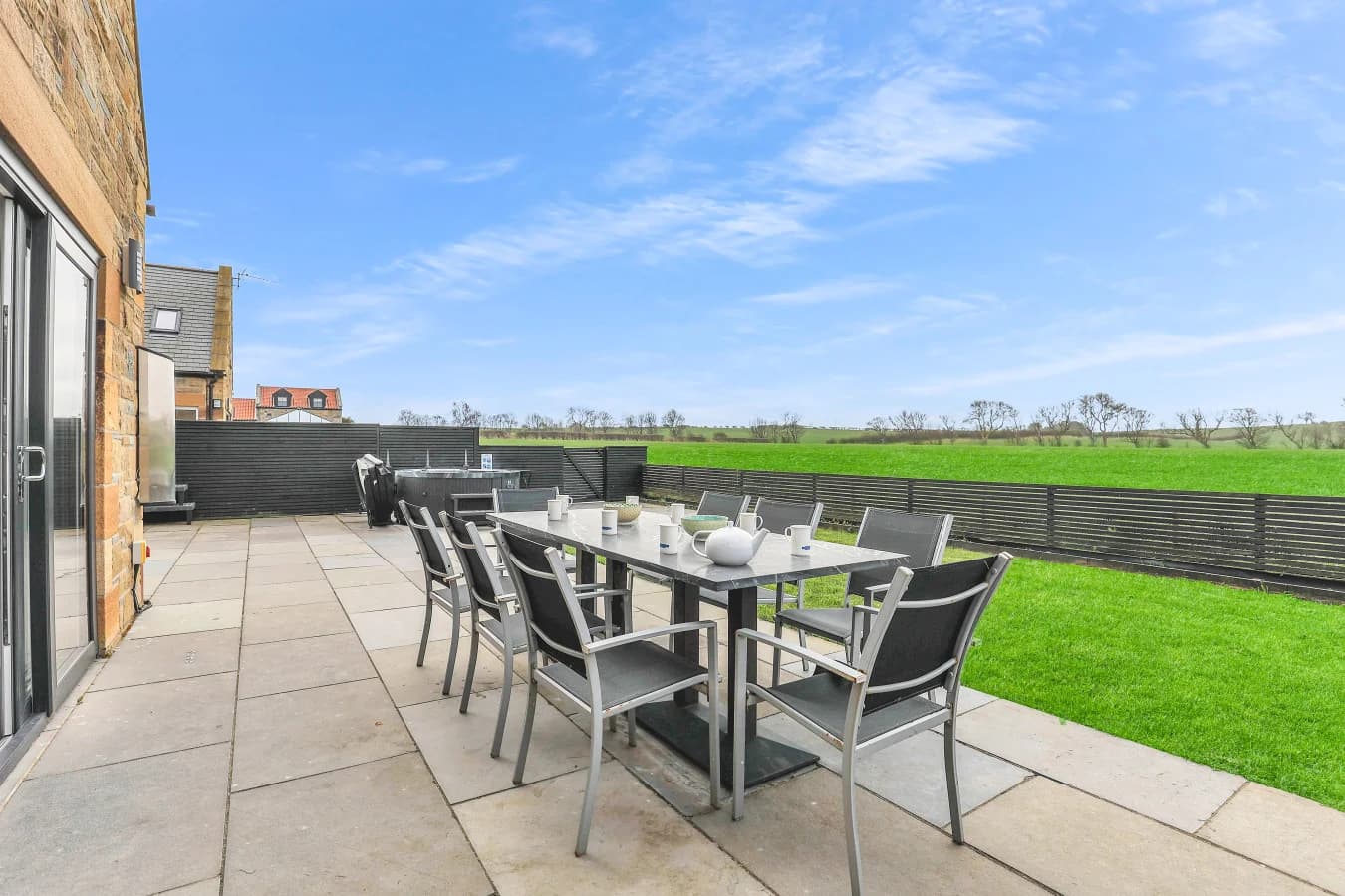 Patio dining area overlooking the enclosed garden and paddocks