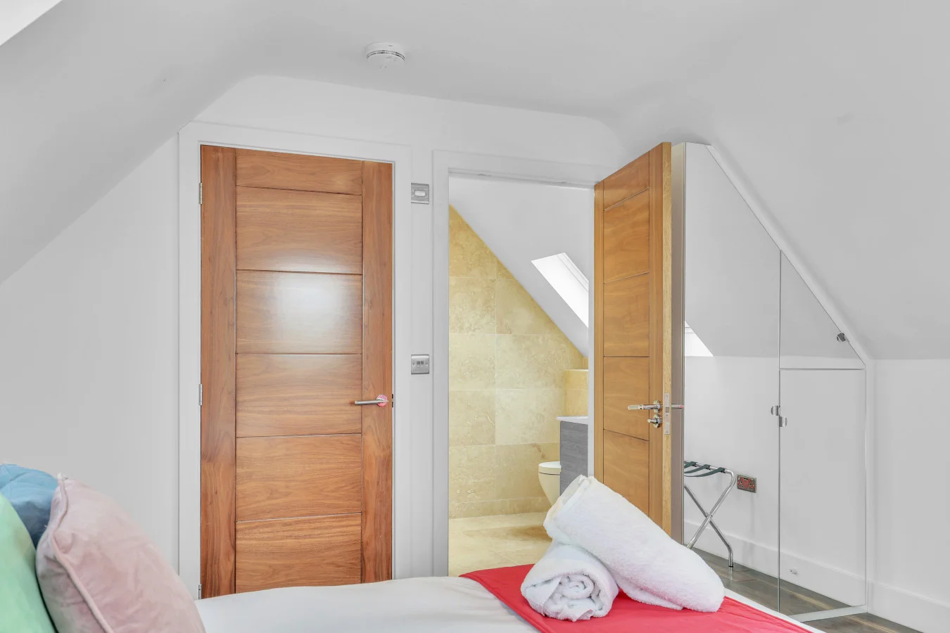 Ensuite bedroom with charming vaulted ceiling