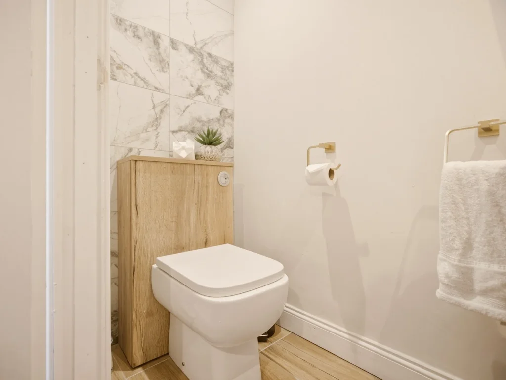 Ground floor cloakroom with wall-hung WC and vanity unit.