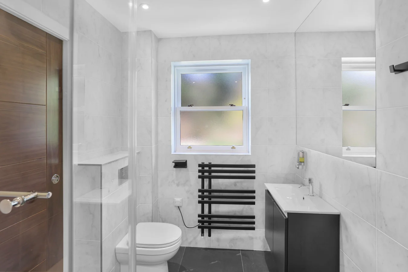 Family bathroom with heated towel rail and vanity unit