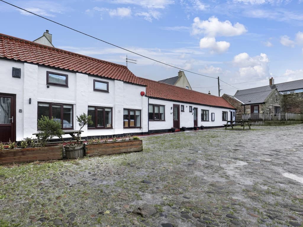 Bright courtyard setting with designated cottage parking spaces