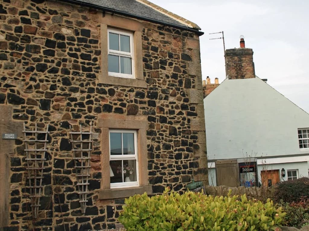 Charming stone exterior of Pegasus Cottage in coastal Craster.