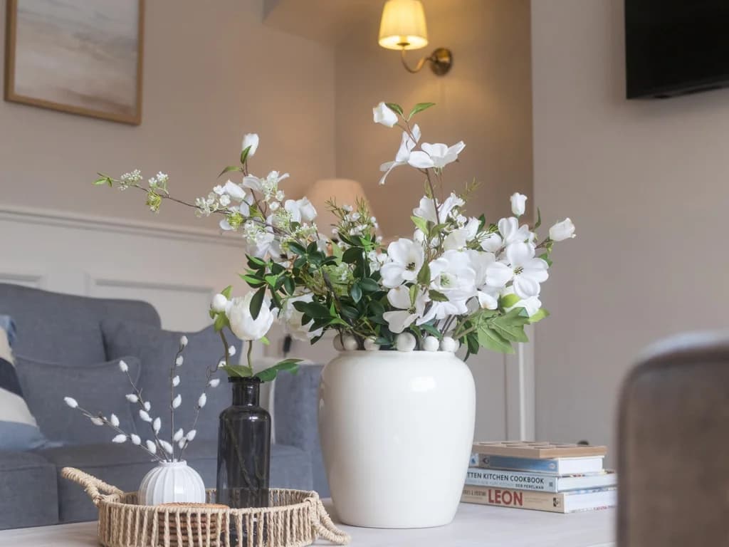 Coffee table with fresh flowers in the bright living room