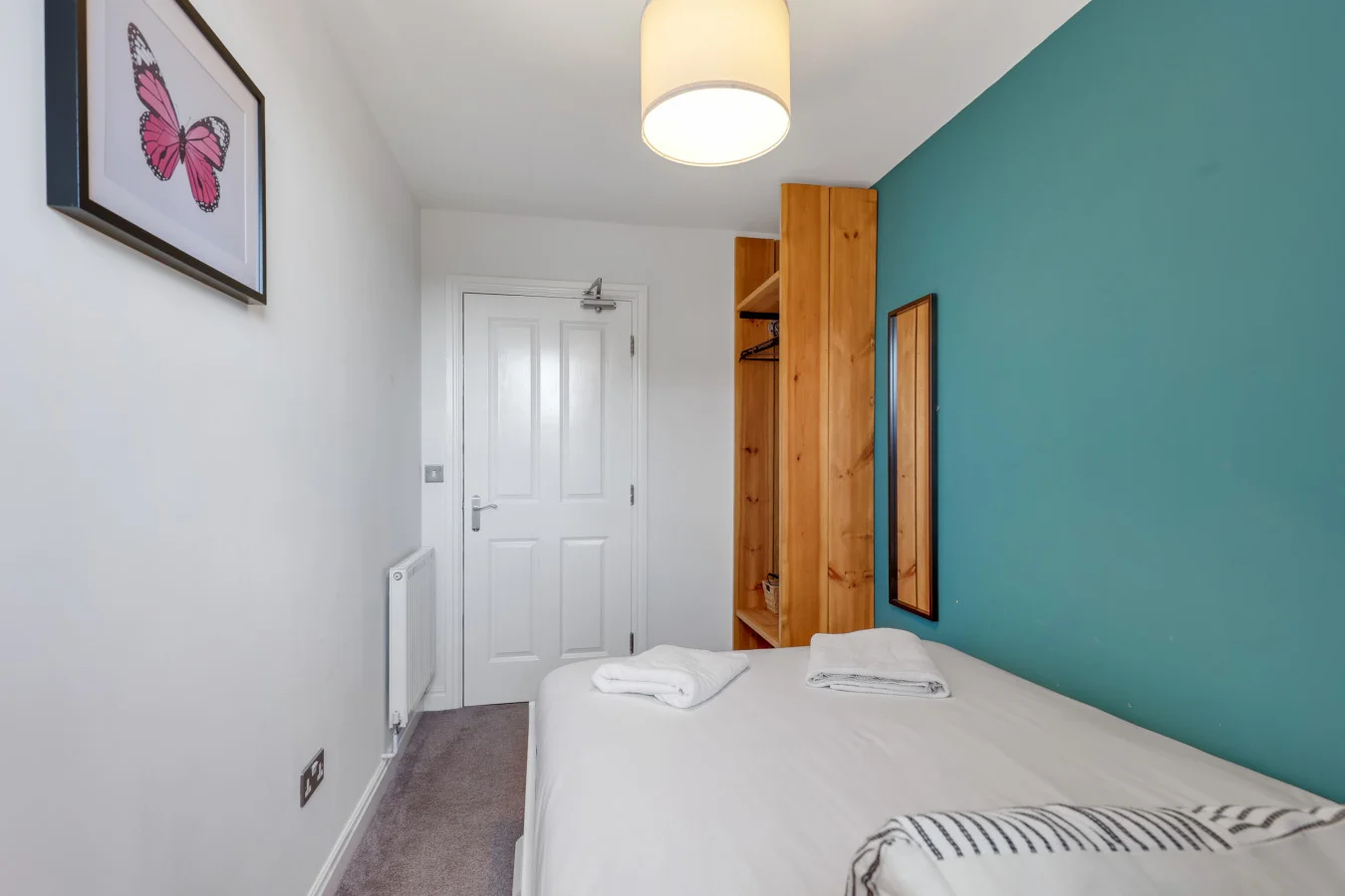 Comfortable guest bedroom with built-in storage and crisp white décor