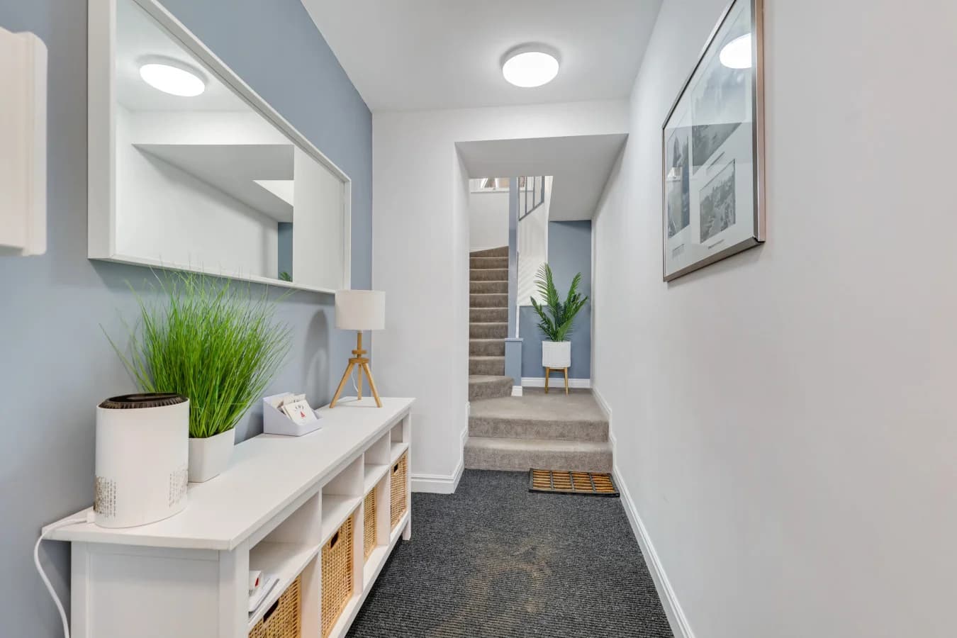 Stylish communal entrance hall with soft blue accents and seating