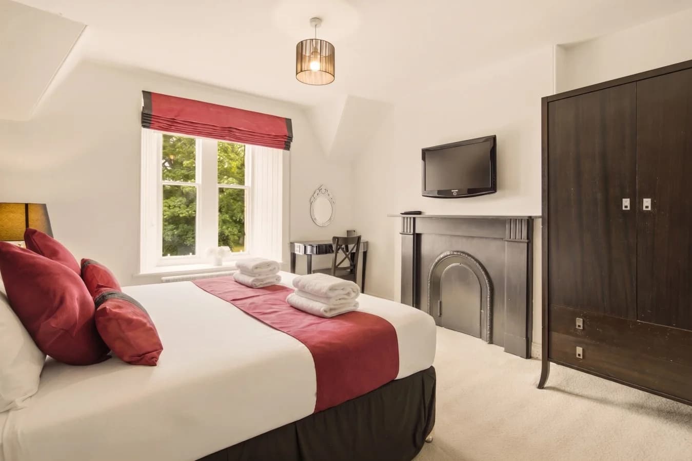 Super king bedroom with en-suite access and wall-mounted TV