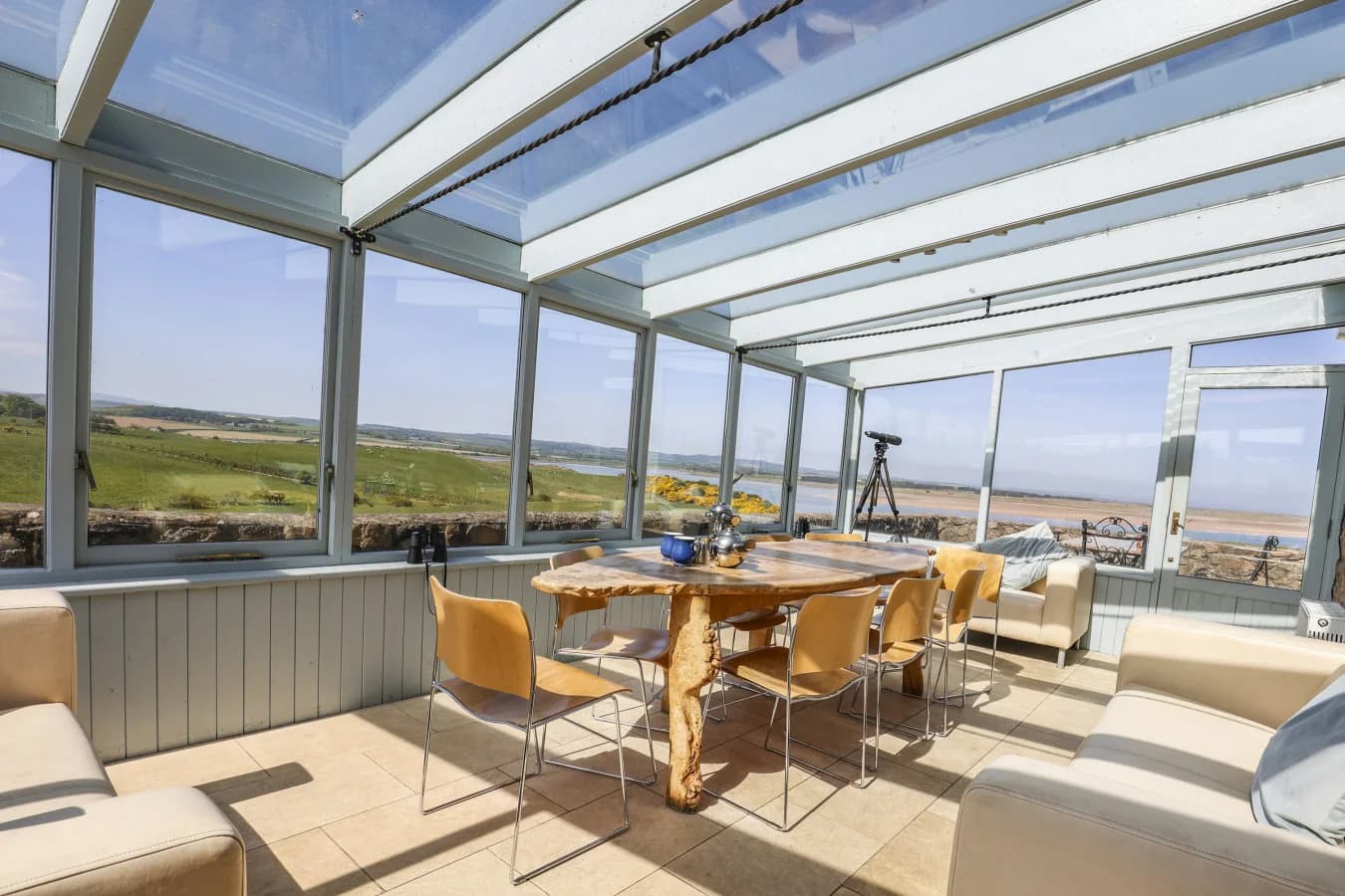 Conservatory dining and seating area with bay views