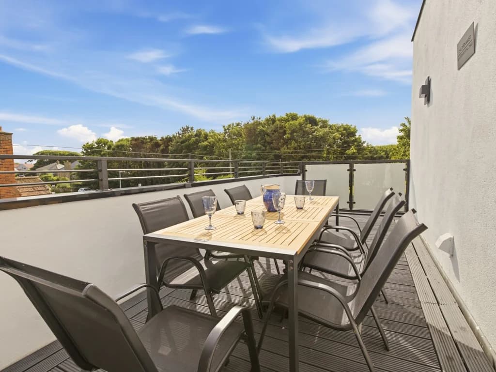 Spacious balcony with outdoor dining and elevated views across Beadnell village