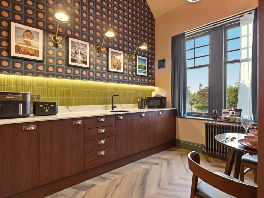 Kitchenette and dining area beside a large window with city views