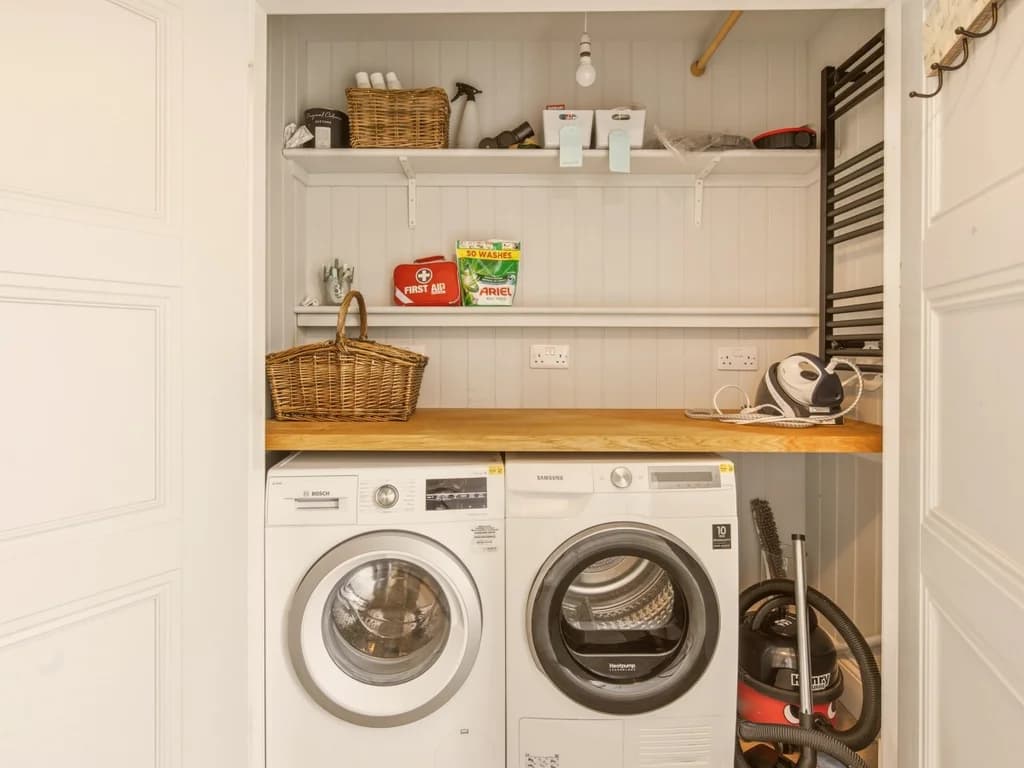 Utility room with washer, dryer, timber worktop and open storage shelves