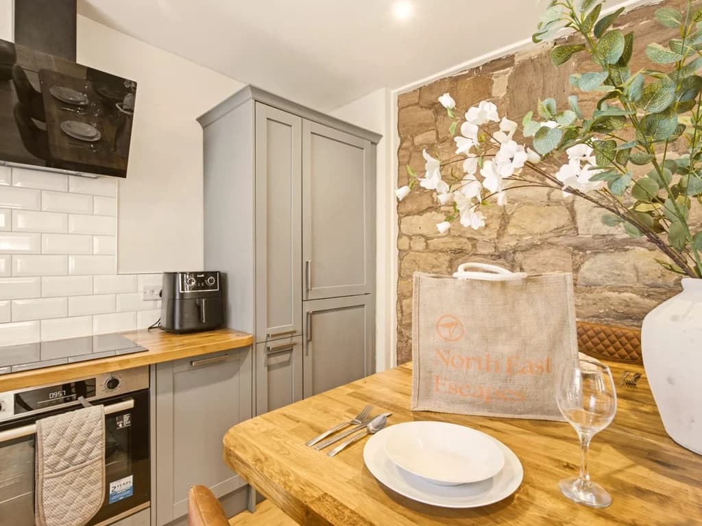 Kitchen details with integrated appliances and wooden worktops.