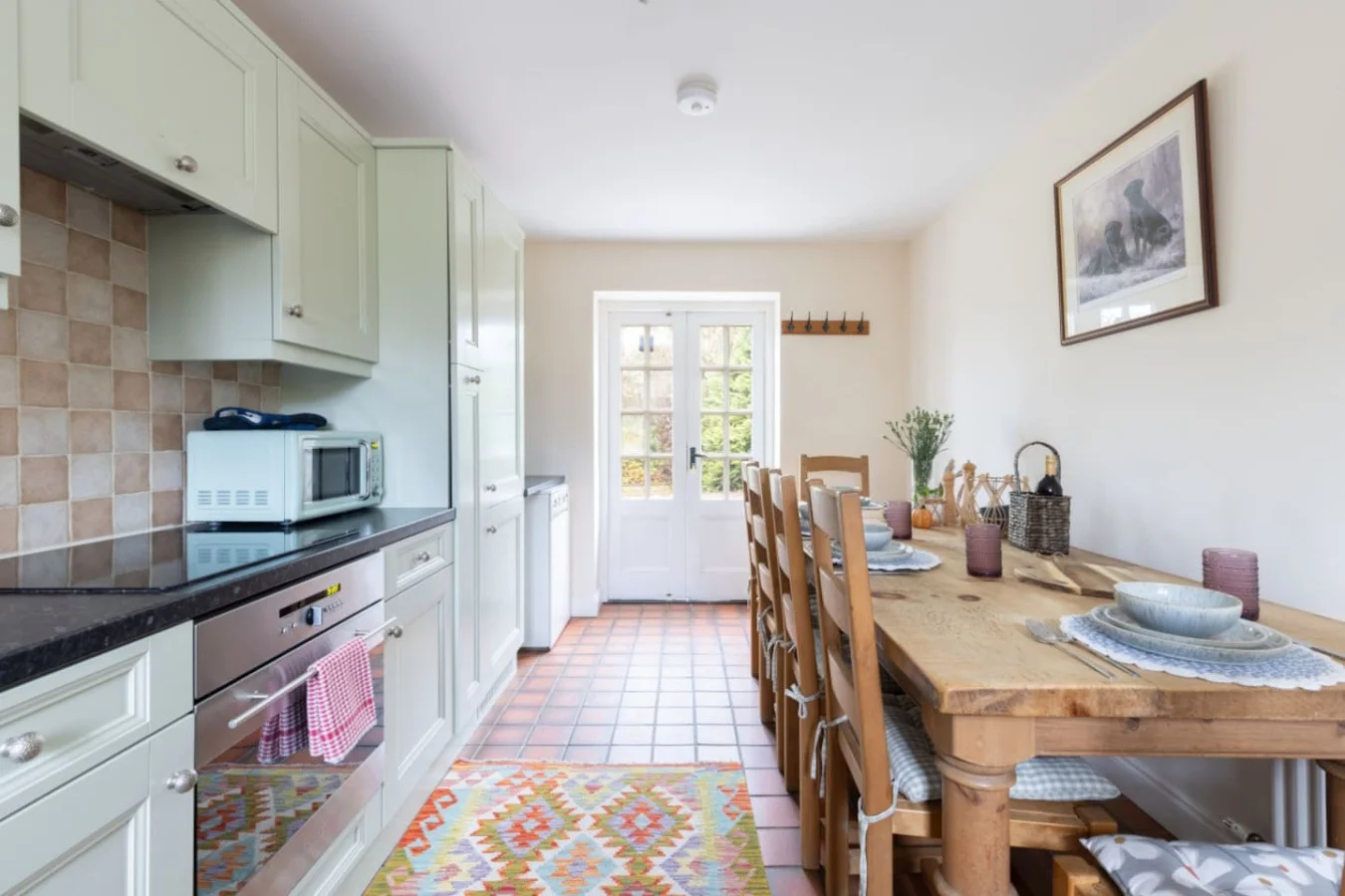 Farmhouse dining kitchen with handmade table and French doors