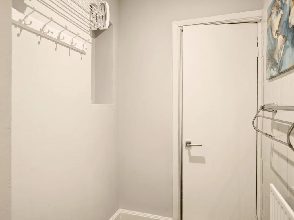 Spacious utility room with coat hooks, heated towel rail and extra storage