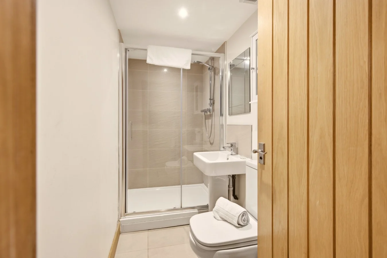 Modern shower room with glass enclosure, wash basin and WC