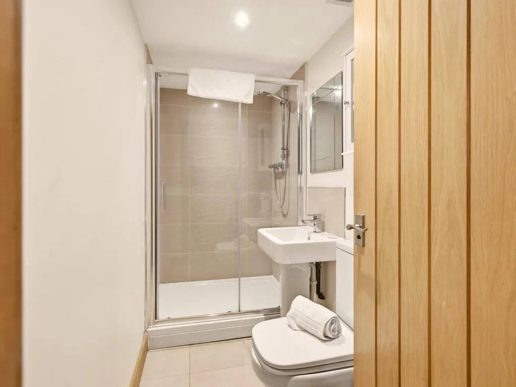 Modern shower room with glass enclosure, wash basin and WC