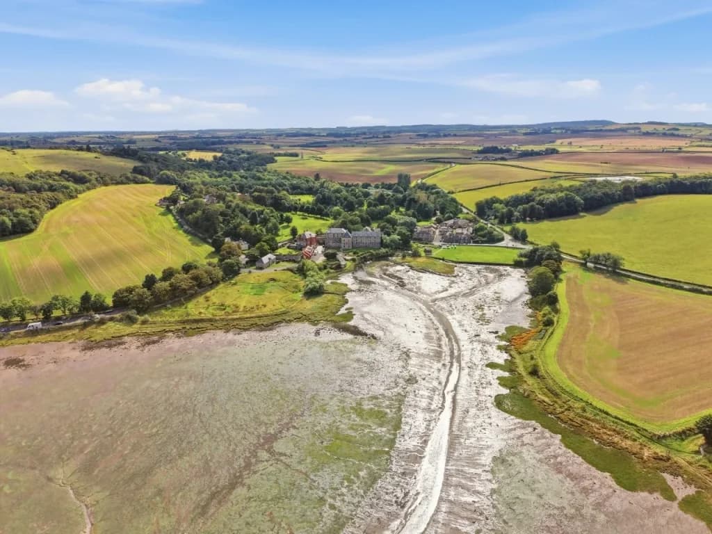 Aerial view over Waren Mill where Waren Burn meets the tidal Budle Bay