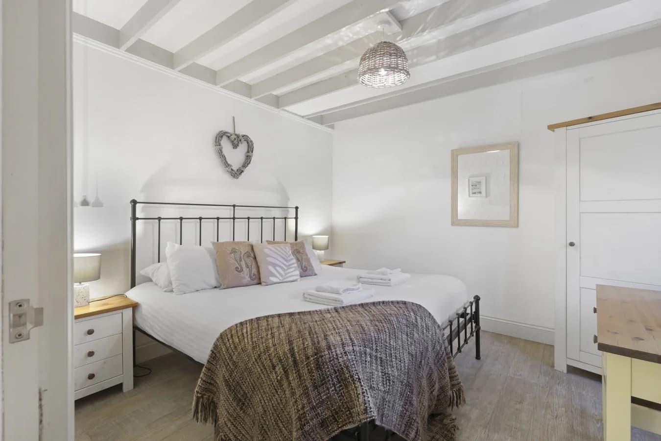 Peaceful sleeping area with textured walls and bedside lighting