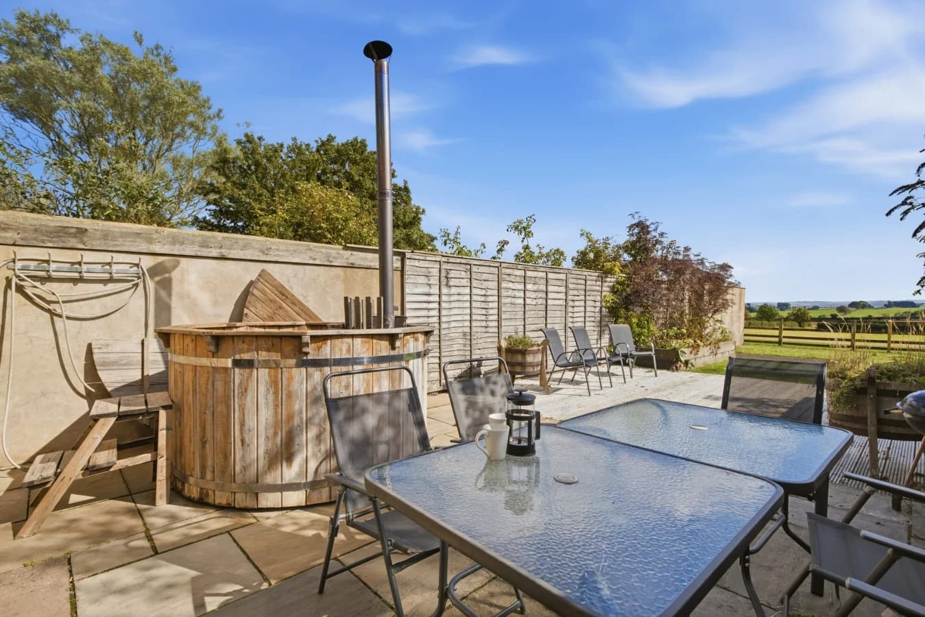 Patio with wood-fired Scandi hot tub and outdoor dining furniture