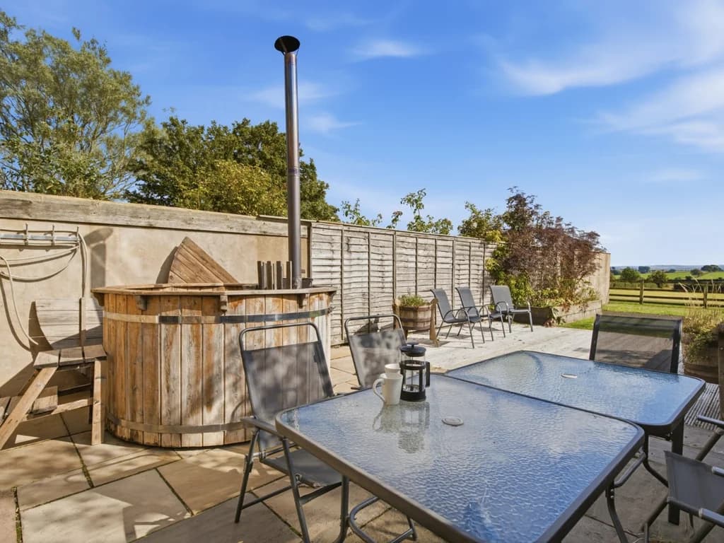 Patio with wood-fired Scandi hot tub and outdoor dining furniture