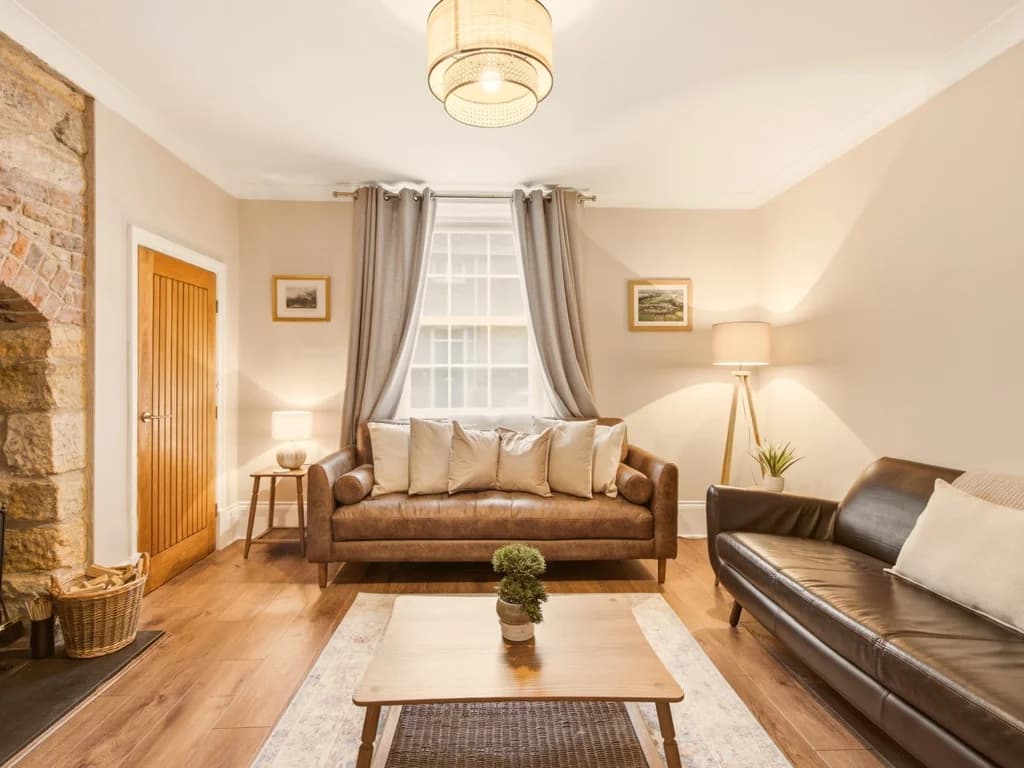 Comfortable living room with feature fireplace and wood-burning stove.