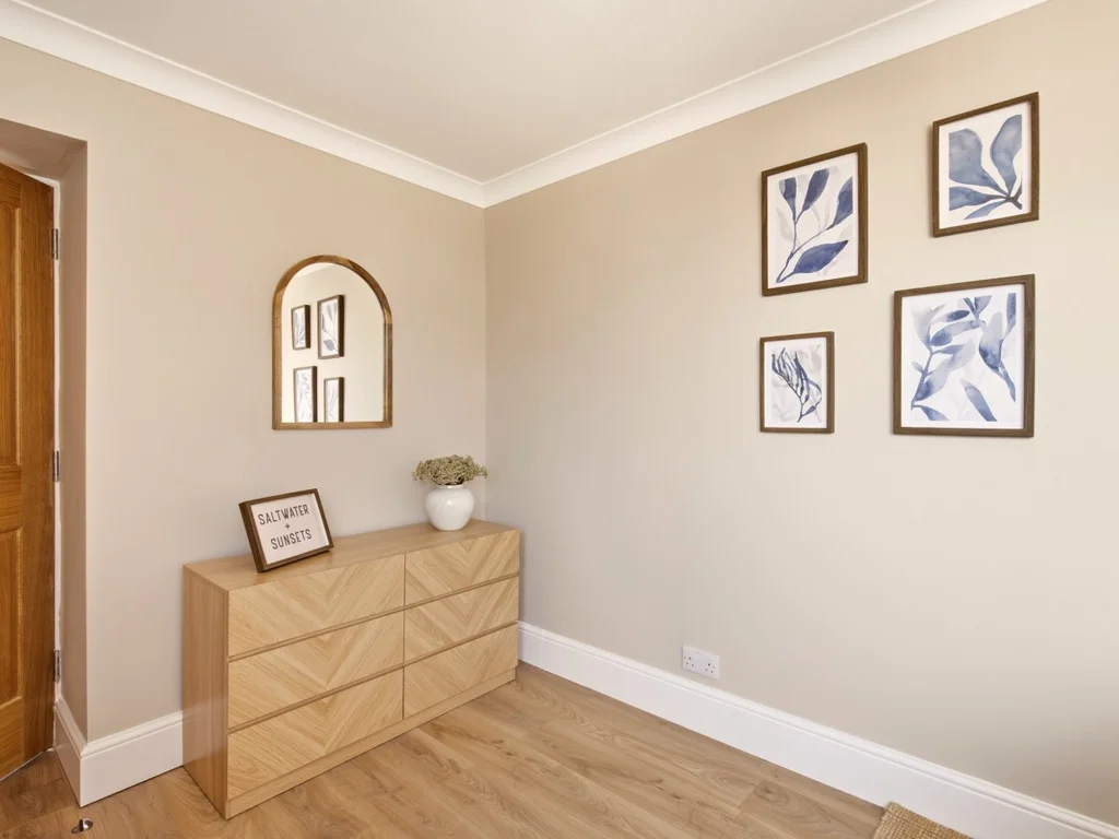 Bedroom with double bed, clothes stand and soft neutral décor.