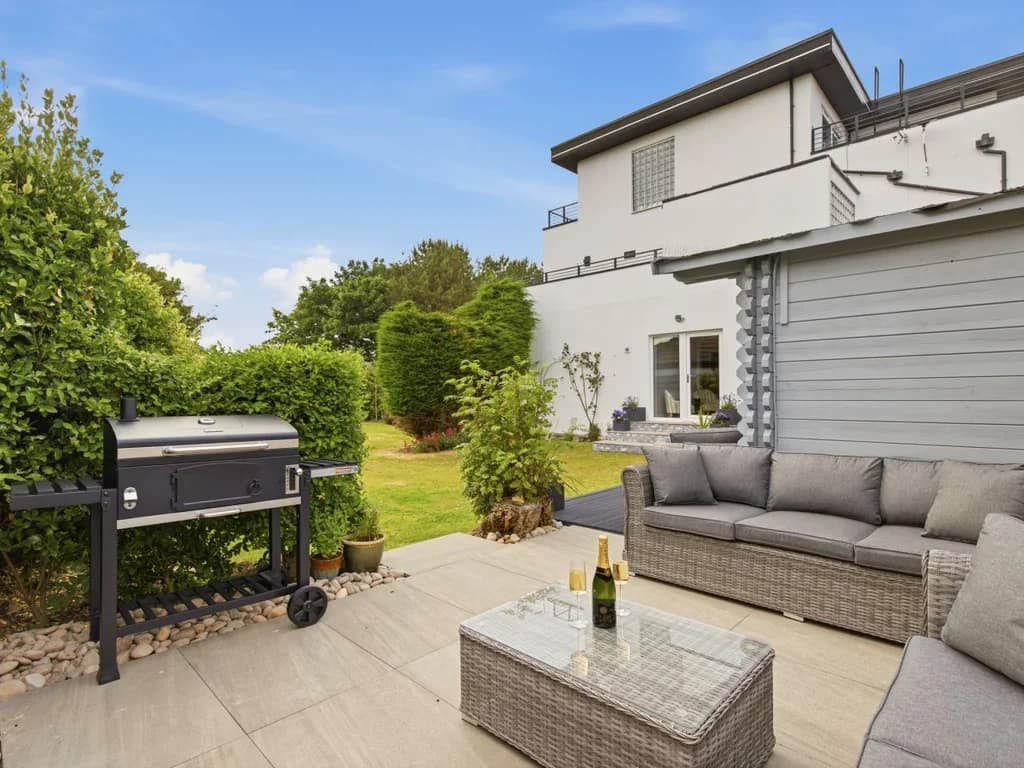 Private patio with outdoor lounge seating and barbecue for alfresco dining