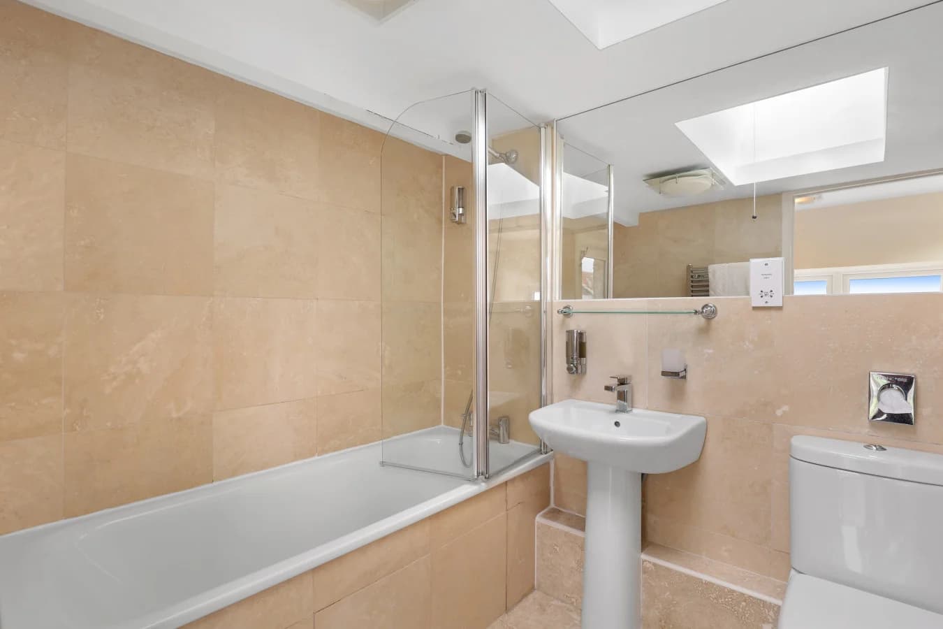 Bathroom with bath and glass shower screen