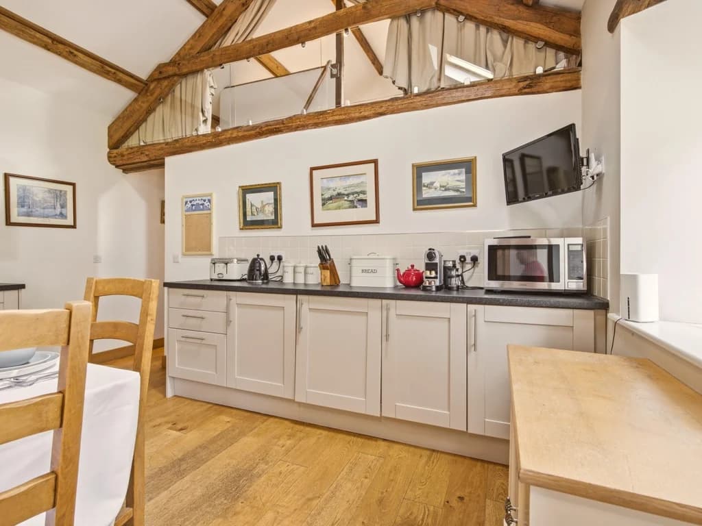 Well-equipped kitchen with ample worktop space and exposed beams