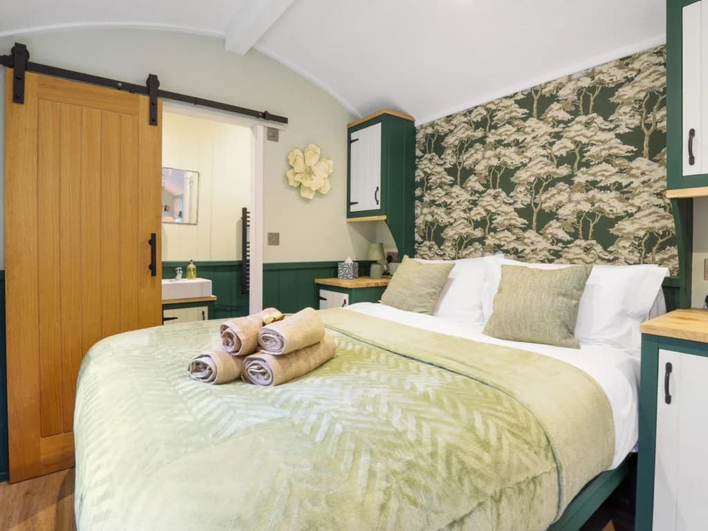 Stylish and comfortable bed with warm green tones, elegant décor