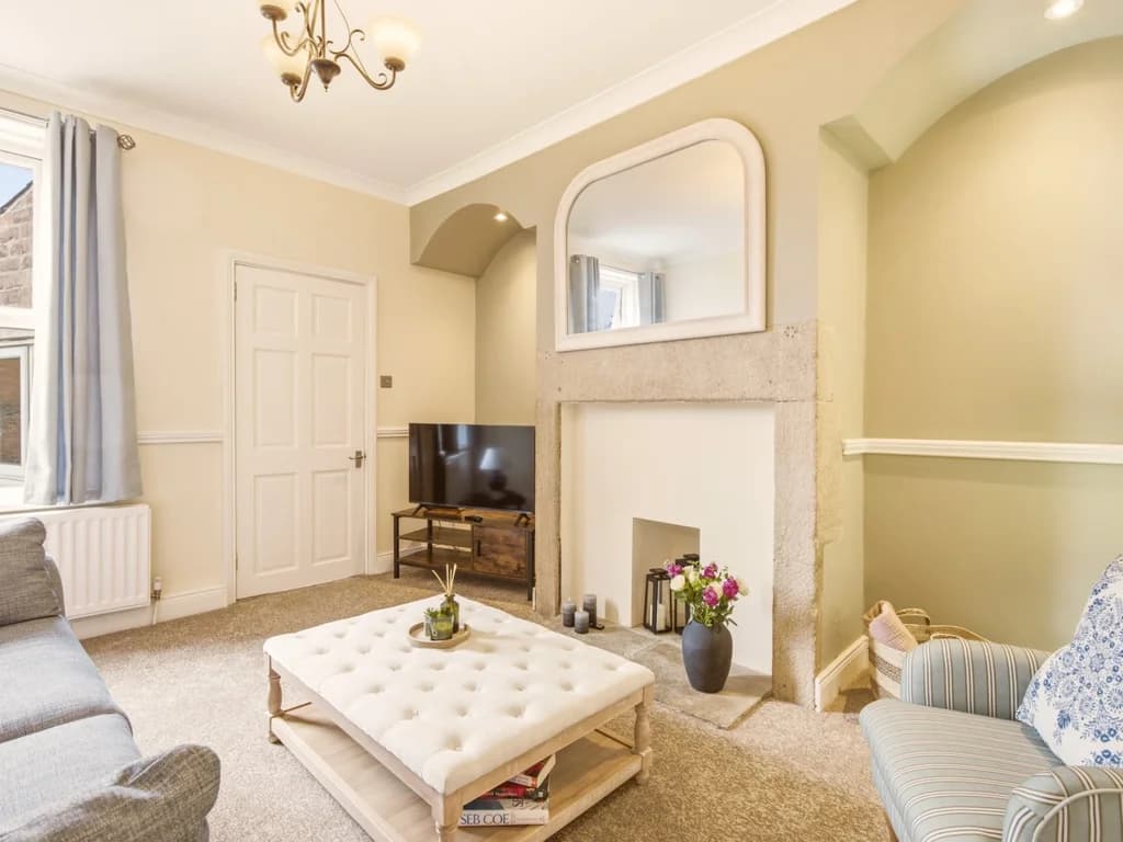 Living room with feature fireplace, Smart TV and arched alcoves.