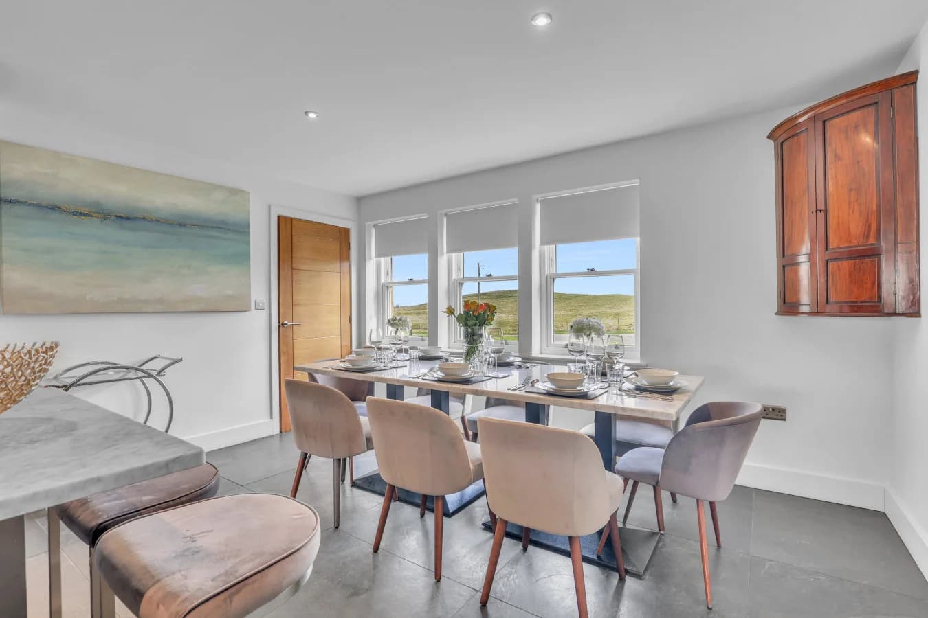 Elegant dining area with seating for eight and countryside views