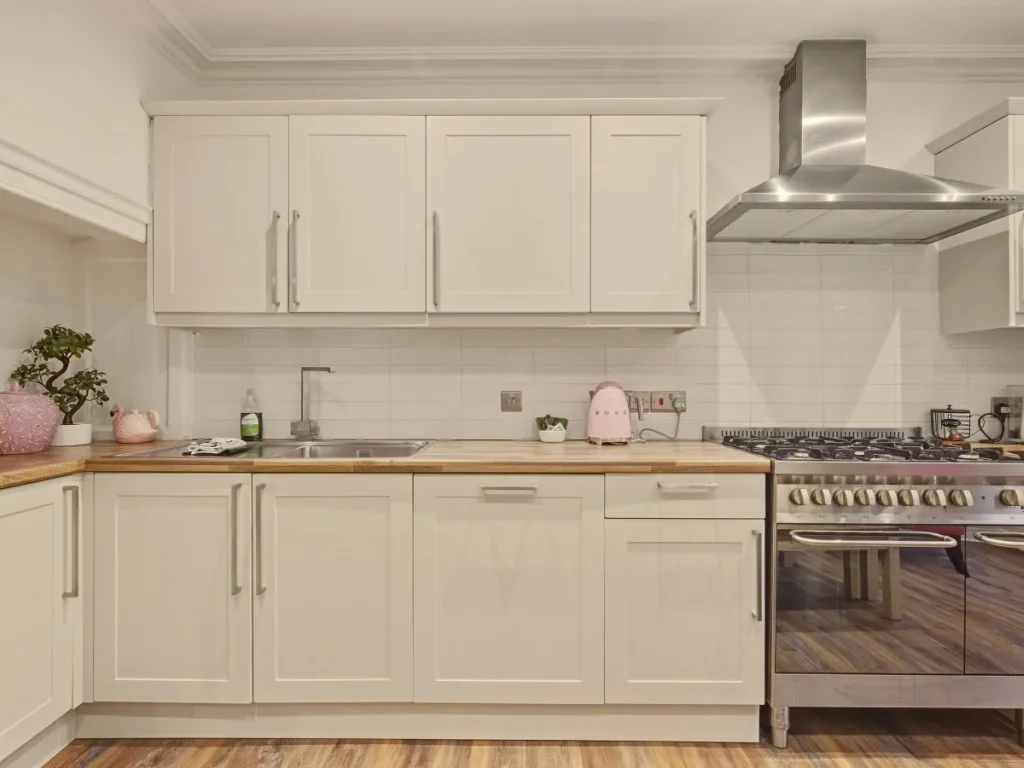 Well-equipped kitchen with gas range, wood worktops and ample storage.