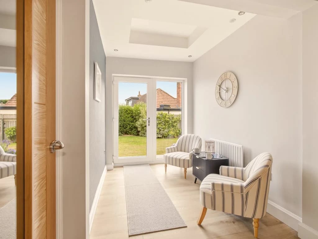 Peaceful ground-floor seating area overlooking the private garden and patio doors