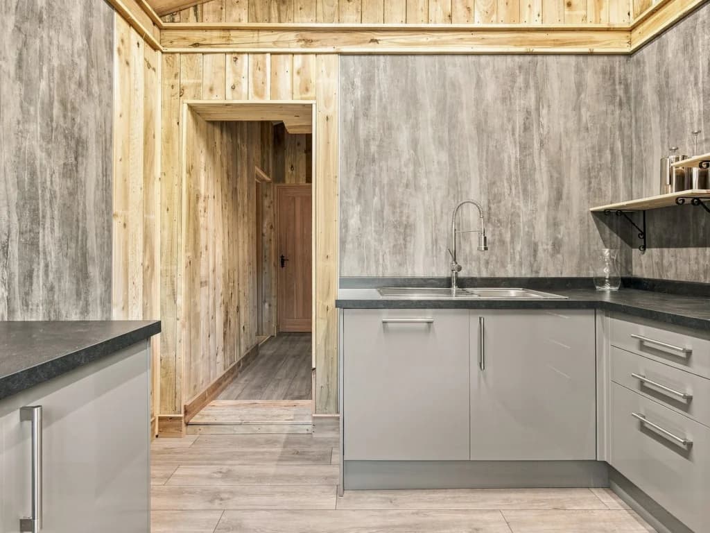 Additional kitchen workspace with sink, storage and serving counters