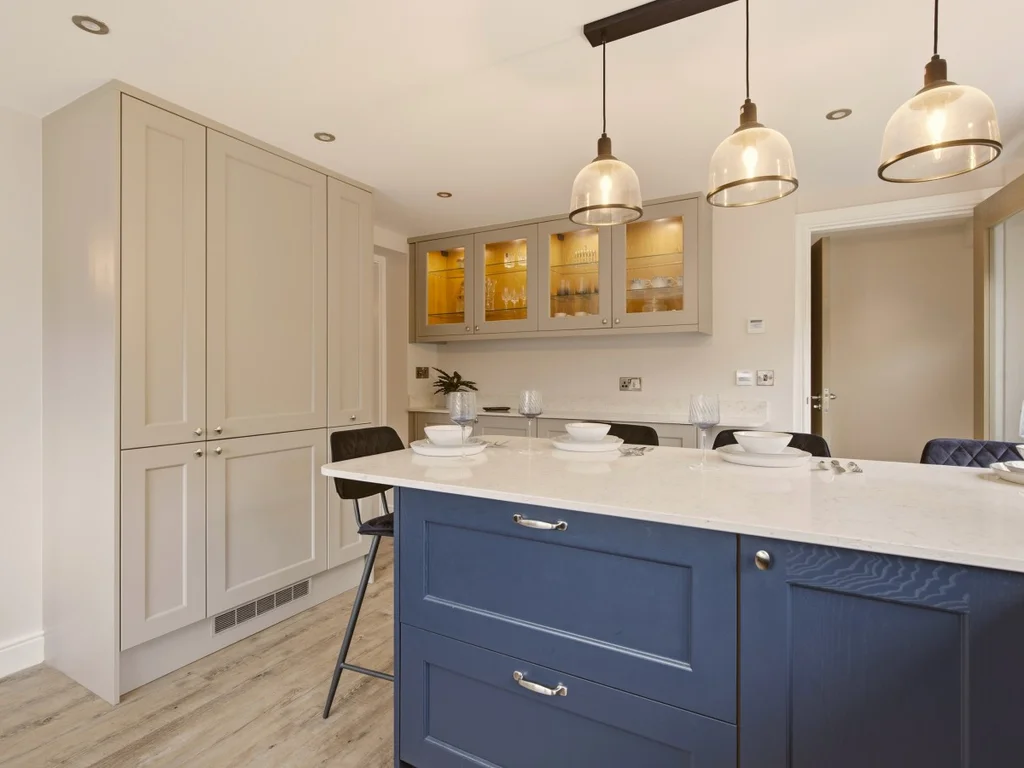 Bright kitchen with large island, pendant lighting and integrated dining area