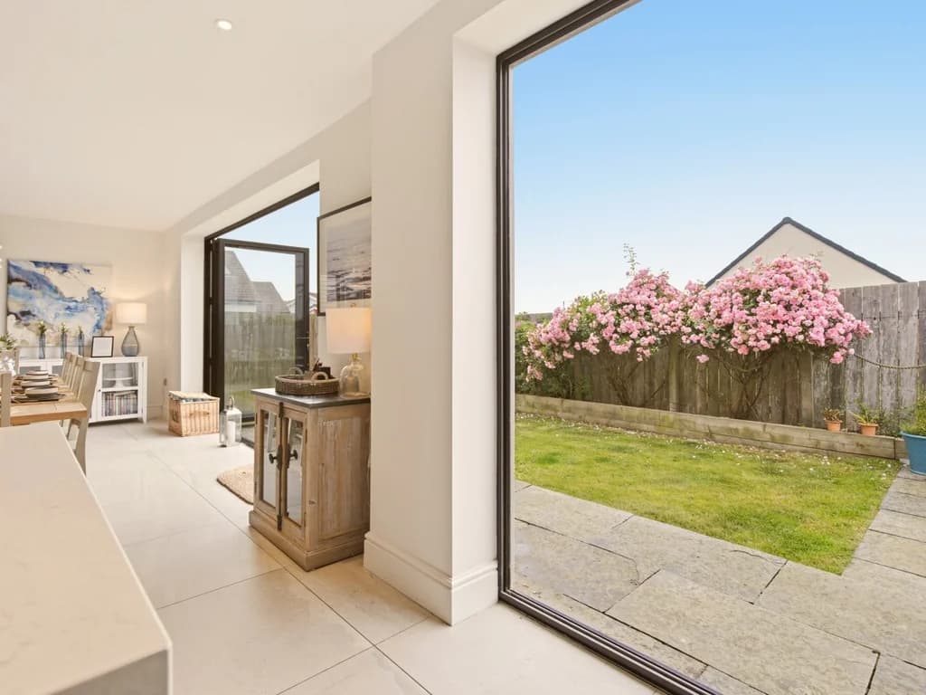Garden view through full-height sliding doors from the open-plan living area