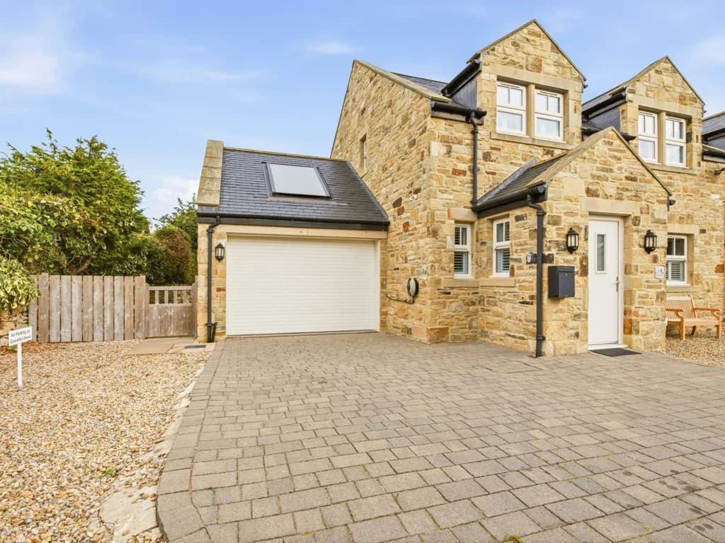 Stone-built exterior with private driveway and adjoining garage