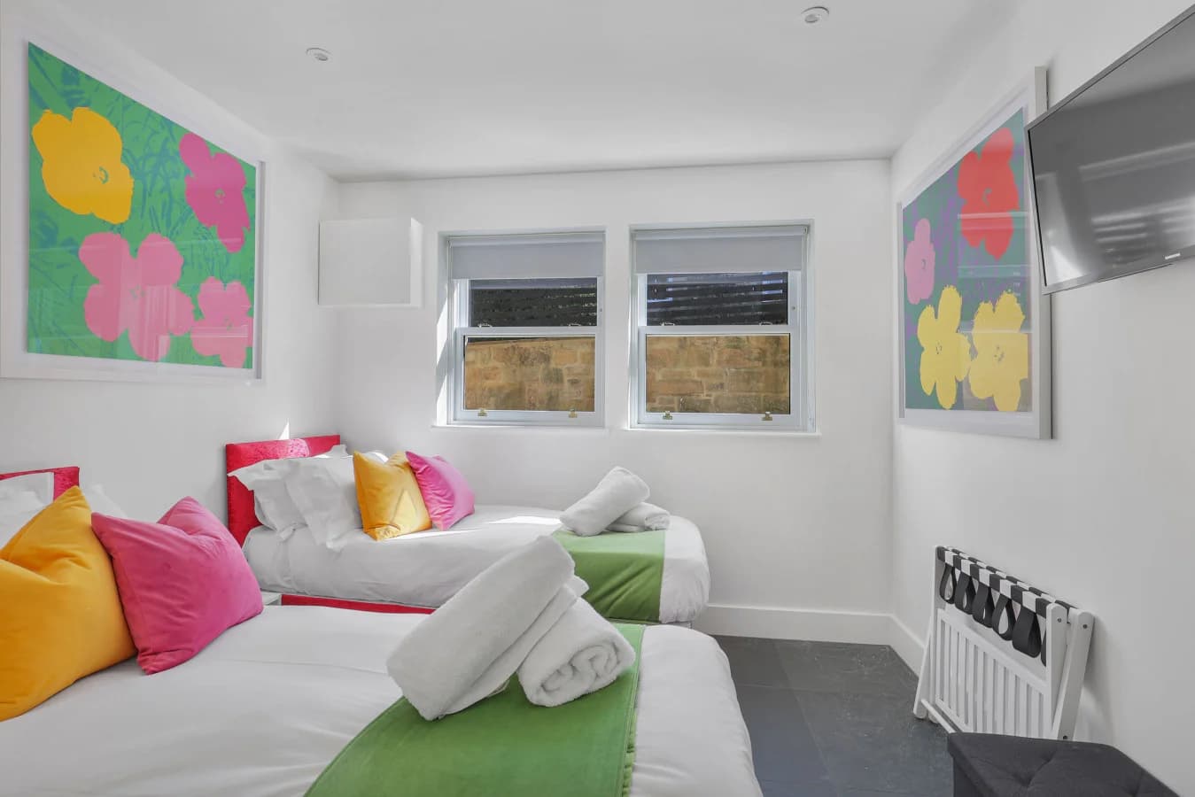 Ground-floor twin bedroom with colourful floral artwork