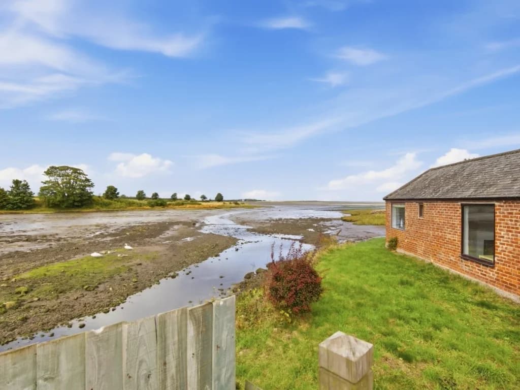 Waterside setting beside Waren Burn with open views across Budle Bay