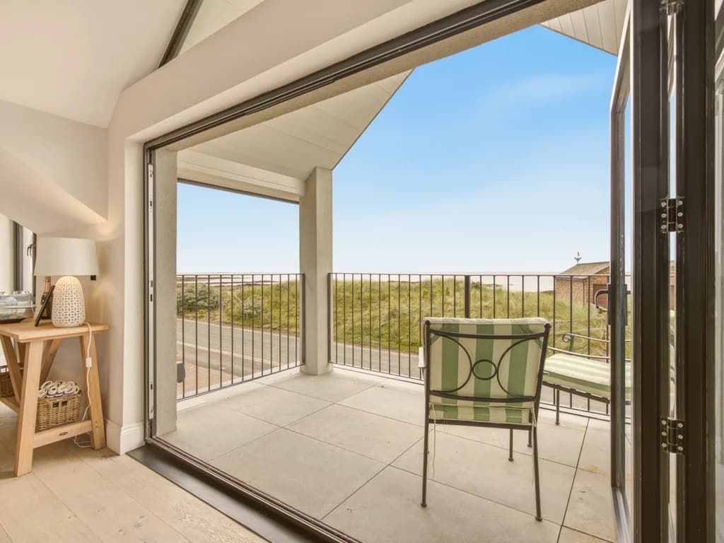 Covered balcony with seating and elevated views across the Beadnell coastline