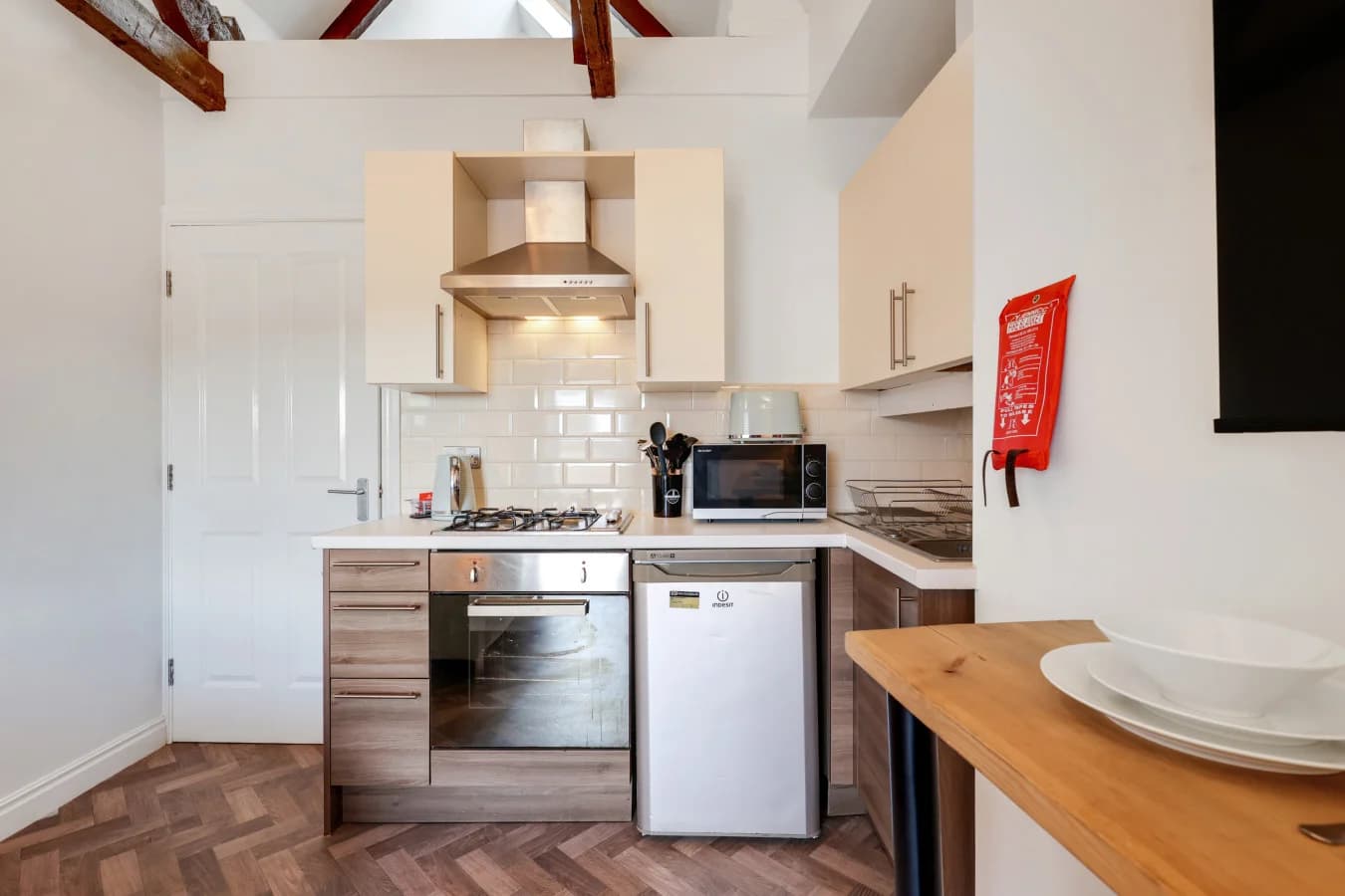 Contemporary kitchen with integrated appliances and breakfast seating