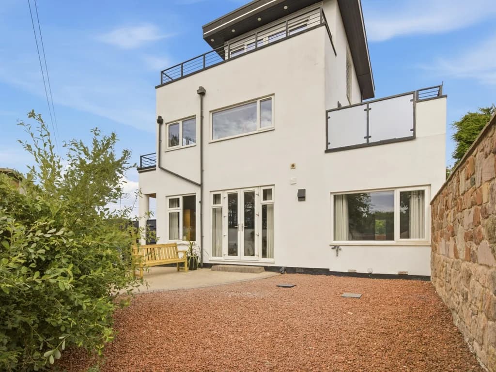 Rear exterior showcasing the spacious three-storey coastal holiday home