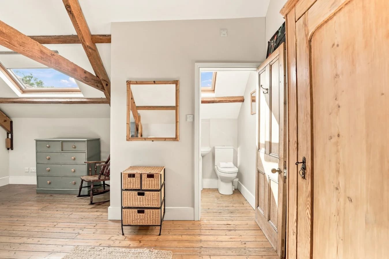 Bedroom storage area with timber beams and adjoining en-suite