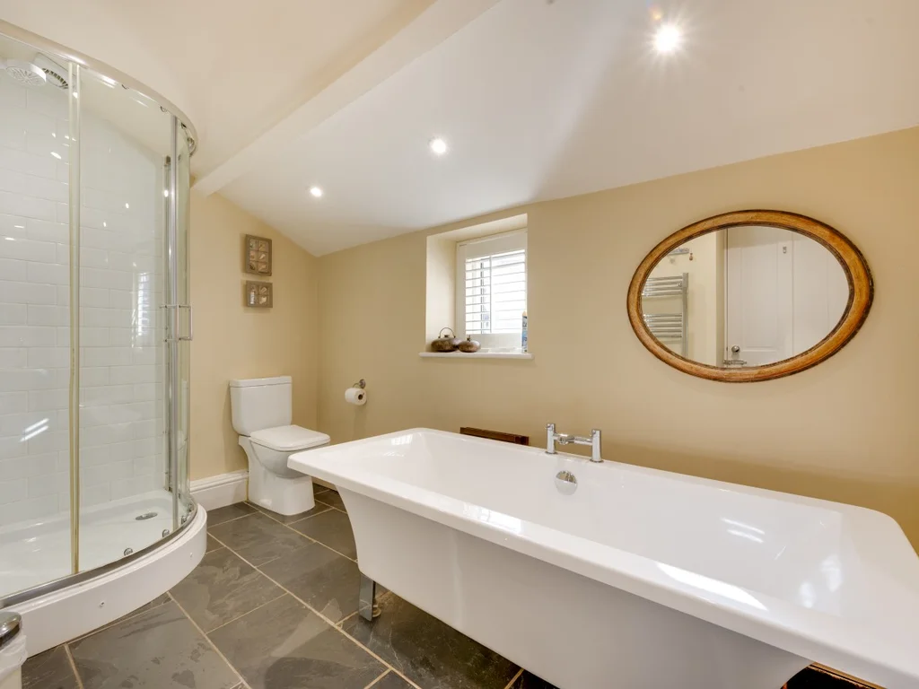 Spacious family bathroom with bath, separate shower and contemporary fittings.
