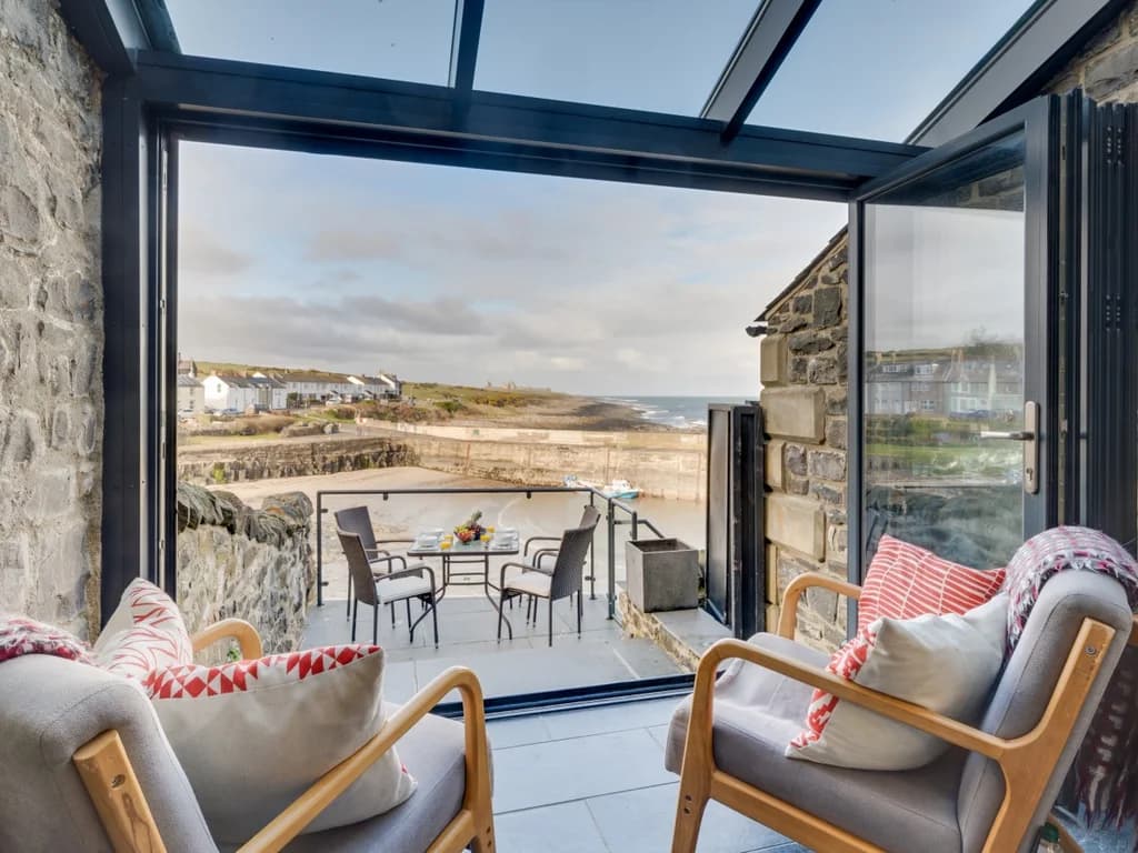 Relaxing coastal seating area opening directly onto the balcony with beautiful harbour views.