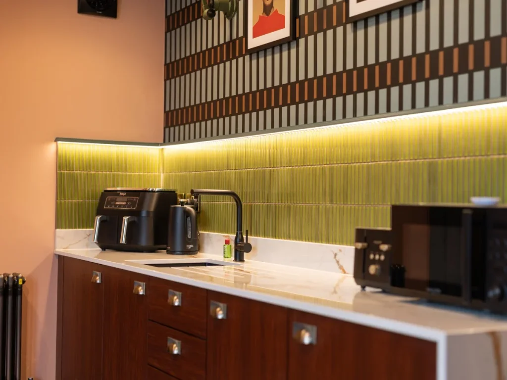 Kitchenette with air fryer, kettle, sink and microwave
