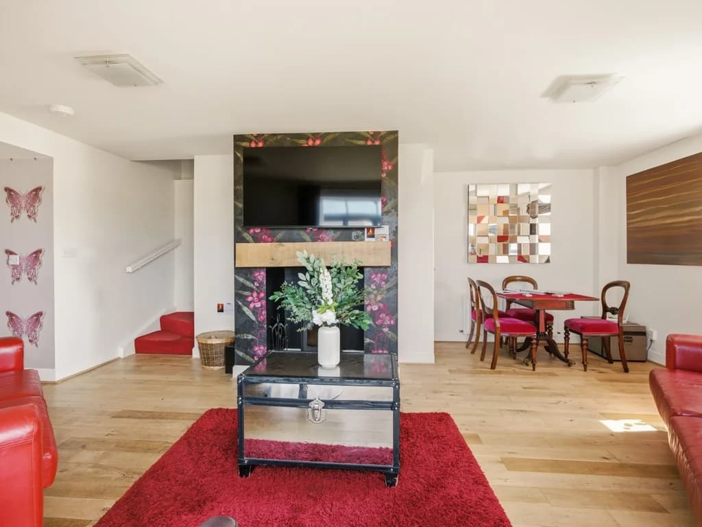 Open-plan living space with TV and access to the dining area